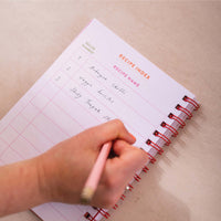 writing down recipe on recipe journal